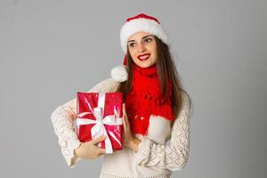 girl in santa hat with gift photo