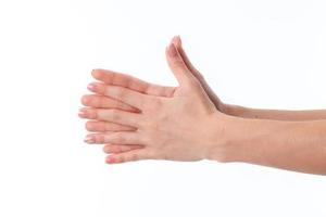 women's hands with crossed palms and fingers between them is isolated on a white background photo