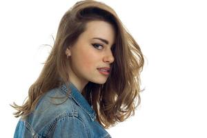 portrait close up of beautiful young brunette with make up in jeans clothes photo