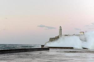 Waves crashing in front of Castillo de los Tres Reyes del Morro in Havana, Cuba. photo