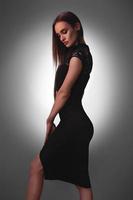 Sexy young lady in black dress in studio photo