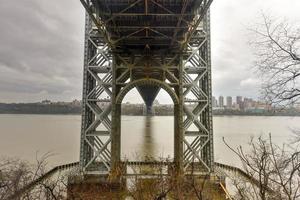 Underside of the George Washington Bridge crossing the Hudson River on a overcast cloudy day from Fort Lee, New Jersey. photo