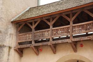 wooden balcony with flowers in pots photo