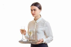 Beautiful young waitress in uniform with trey in hands photo