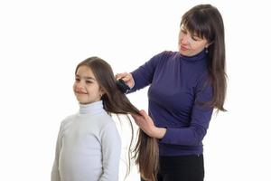 an adult woman combing her hair little girl photo