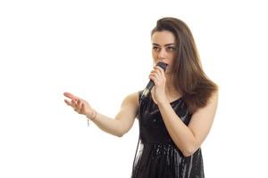pretty young girl in black dress singing a karaoke photo