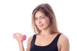 close-up of a smiling sporty girl who is holding a dumbbell photo