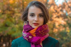 Portrait of a young beautiful girl in  warm pink scarf close-up photo