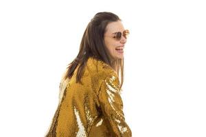 glamorous young lady in the Golden jacket looks away and laughs photo