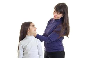 Cheerful little girl with mother in studio looking at each others photo