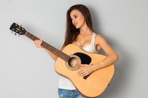 young brunette woman with guitar photo