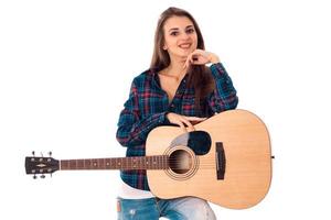stylish brunette girl playing guitar photo