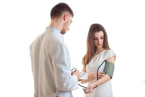 a young doctor in a white lab coat takes pressure cute girl photo