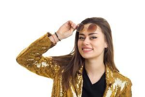 Cheerful elegant woman in golden jacket smiling on camera photo