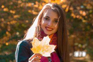 Portrait of a young beautiful girl kotooraja keeps  large sheet and smiling photo