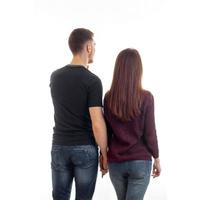 a young couple standing with back to the camera and are coming forward photo