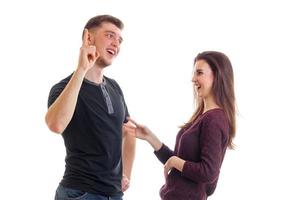 joyful young man stands with his cheerful girl and raises a finger up photo