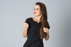 girl in black dress posing in studio photo