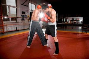 Two men is boxing on the ring photo