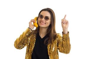 Cheerful elegant woman in golden jacket and sunglasses photo