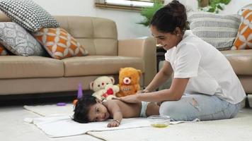 Stock video footage of mother giving back massage to her infant baby.