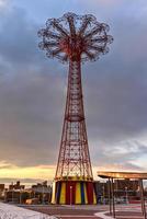 New York City - December 10, 2017 -  Coney Island Boardwalk with Parachute Jump at Coney Island, NY The boardwalk, built in 1923, stretches for 2.51 miles photo