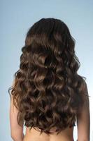 girl with long curly hair from behind photo