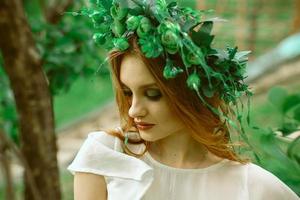 girl with closed eyes and wreath on head photo