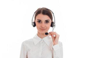 pretty young brunette call office worker woman with headphones and microphone looking at the camera isolated on white background photo