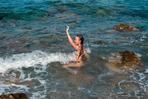 Cutie girl having fun in sea summer time photo