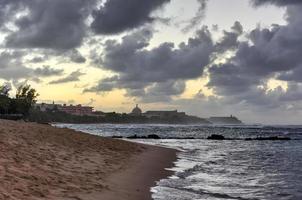 Beach with waves crossing against the rocks off of San Juan, Puerto Rico. photo