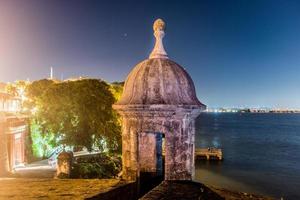 Lookout Tower along the walls of Old San Juan, Puerto Rico from Plaza de la Rogativa with a view of the San Juan Gate. photo