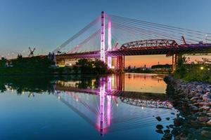 New and old Kosciuszko bridges joining Brooklyn and Queens in New York City across Newtown Creek. The new bridge is a cable-stayed bridge while the old bridge from 1939 is truss bridge. photo