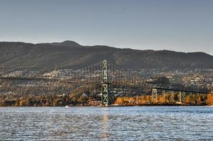 Lions Gate Bridge as seen from Stanley Park in  Vancouver, Canada. The Lions Gate Bridge, opened in 1938, officially known as the First Narrows Bridge, is a suspension bridge. photo