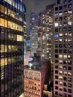 New York cityscape at night up close of towering building. photo