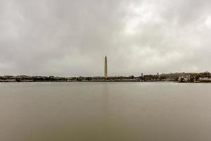 Cherry blossoms at the tidal basin with Washington Monument in spring season in Washington DC, USA. photo