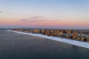 Aerial view of a snow covered Coney Island Beach during the winter at sunrise in Brooklyn, New York photo