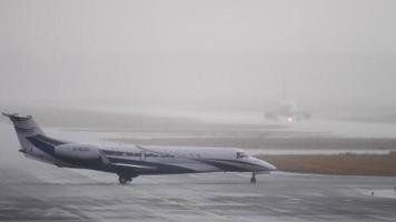 FRANKFURT AM MAIN, GERMANY JULY 20, 2017 - Luxaviation Embraer Legasy 650 G GLEG taxiing before departure at runway 25C, hard rain. Fraport, Frankfurt, Germany video