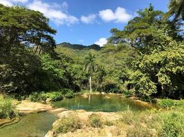 El Nicho Waterfalls in Cuba. El Nicho is located inside the Gran Parque Natural Topes de Collantes, a forested park that extends across the Sierra Escambray mountain range in central Cuba. photo