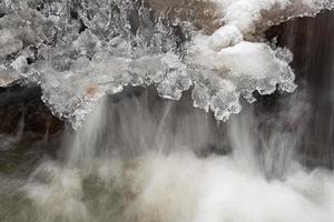 A Small Rocky Forest River in Winter photo