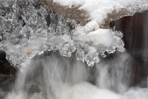 A Small Rocky Forest River in Winter photo