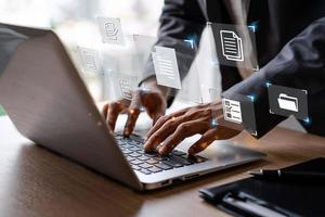 Businessman working and using a computer to manage online documentation database and digital file storage in the office, Document Management System concept photo