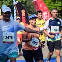 New Delhi, India - October 16 2022 - Vedanta Delhi Half Marathon race after covid in which marathon participants about to cross the finish line, Delhi Half Marathon 2022 photo