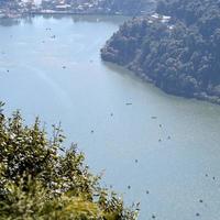 Full view of Naini Lake during evening time near Mall Road in Nainital, Uttarakhand, India, Beautiful view of Nainital Lake with mountains and blue sky photo