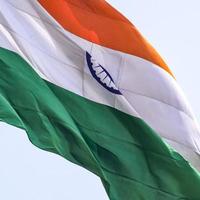 India flag flying high at Connaught Place with pride in blue sky, India flag fluttering, Indian Flag on Independence Day and Republic Day of India, tilt up shot, Waving Indian flag, Har Ghar Tiranga photo