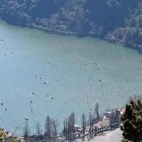 Full view of Naini Lake during evening time near Mall Road in Nainital, Uttarakhand, India, Beautiful view of Nainital Lake with mountains and blue sky photo