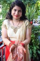 Beautiful woman dressed up as Indian tradition with henna mehndi design on her both hands to celebrate big festival of Karwa Chauth, Karwa Chauth celebrations by Indian woman for her husband photo