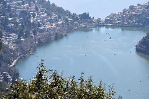 Full view of Naini Lake during evening time near Mall Road in Nainital, Uttarakhand, India, Beautiful view of Nainital Lake with mountains and blue sky photo