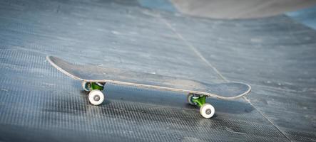 One skateboard on the road. Extreme sport challenge and skateboarder competition, close up picture of skate photo