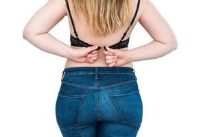 Overweight woman with fat back and buttocks, obese female body on white background photo